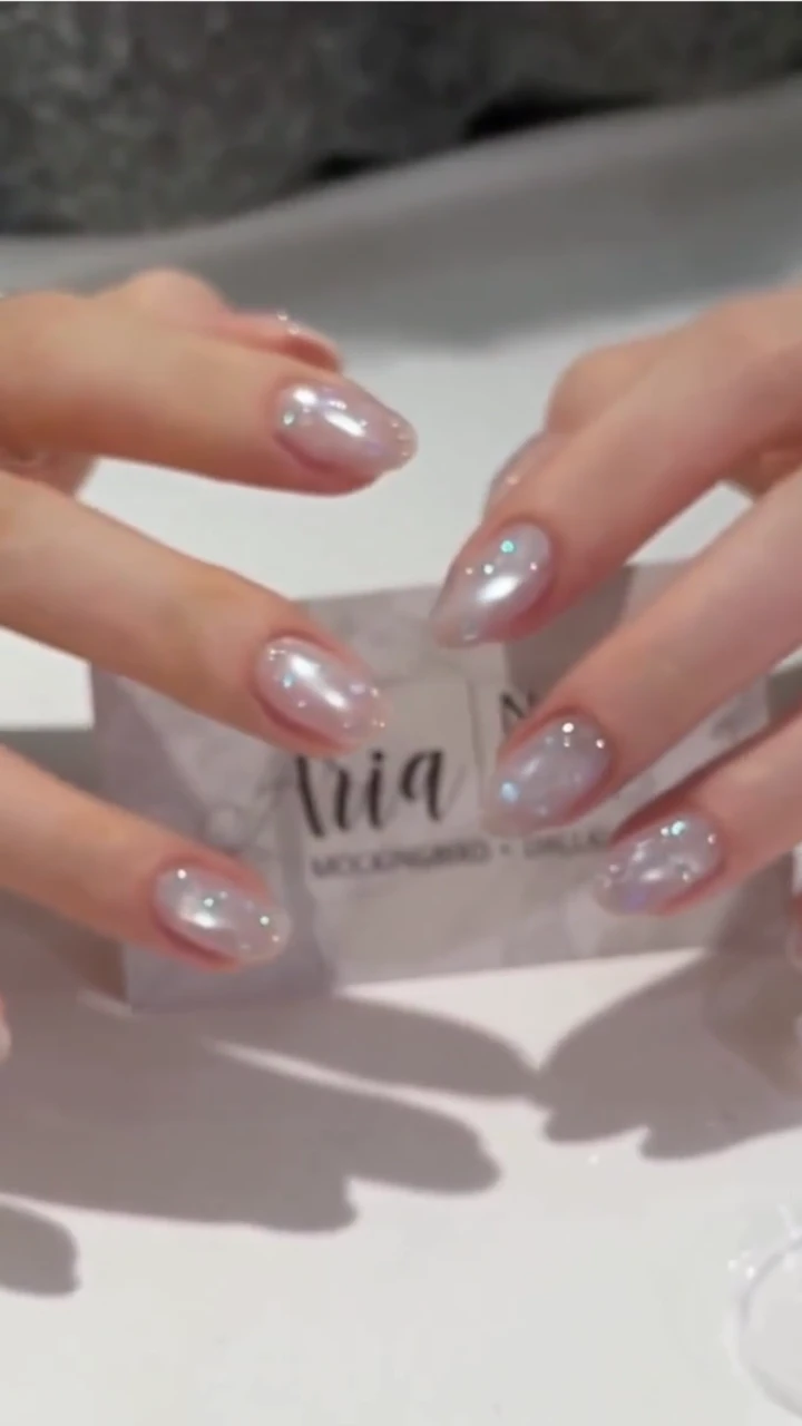 Pearlescent cat-eye nails catching the light